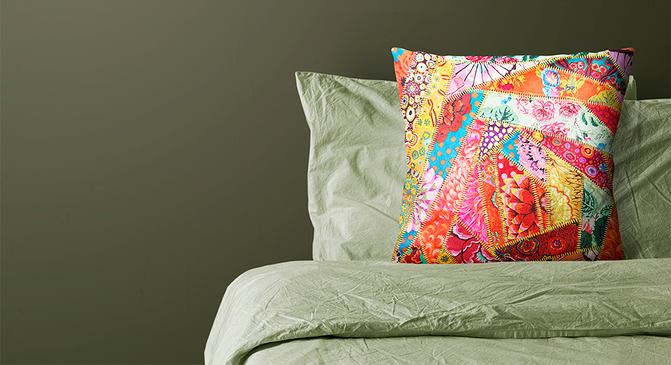 A finished serger pattern project styled on a bed