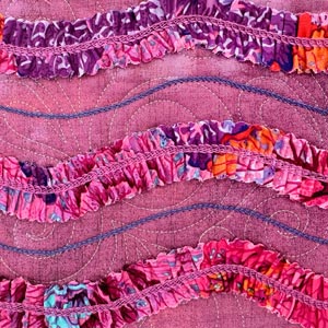 A finished serger pattern project styled on a bed